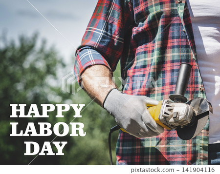 Happy Labor Day. Handsome man and angle grinder Happy Labor Day. Handsome man and angle grinder 141904116