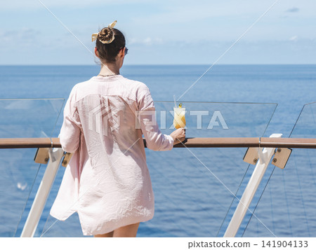 Fashionable woman standing on the empty deck 141904133