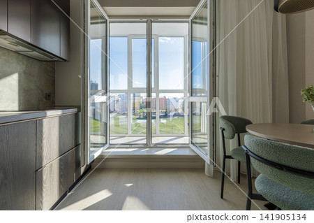 Modern Kitchen Interior with Open French Doors and View of Balcony Modern Kitchen Interior with Open French Doors and View of Balcony 141905134
