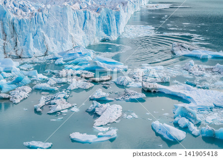 Perito moreno glaciers icy blue glacier front with floating ice in cold water and ripples Perito moreno glaciers icy blue glacier front with floating ice in cold water and ripples 141905418