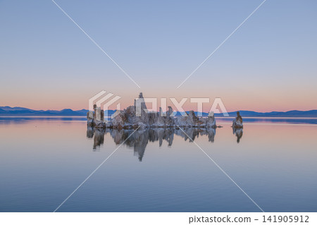 Serene tufa towers reflect on peaceful lake water during dusk near sierra nevada mountain range bringing calm tranquil mood Serene tufa towers reflect on peaceful lake water during dusk near sierra nevada mountain range bringing calm tranquil mood 141905912