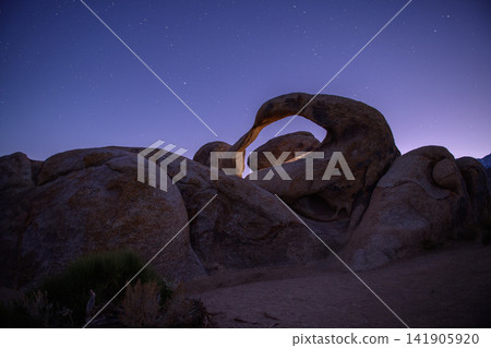 Majestic natural arch rock formation under peaceful night sky in sierra nevada desert landscape offers serene wondrous emotion Majestic natural arch rock formation under peaceful night sky in sierra nevada desert landscape offers serene wondrous emotion 141905920