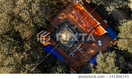 A top down aerial view of Wat Phra That Chom Kitti in Chiang Rai. The square tiered pagoda base rests on red brick courtyard tiles on 13 January 2023. A top down aerial view of Wat Phra That Chom Kitti in Chiang Rai. The square tiered pagoda base rests on red brick courtyard tiles on 13 January 2023. 141906143