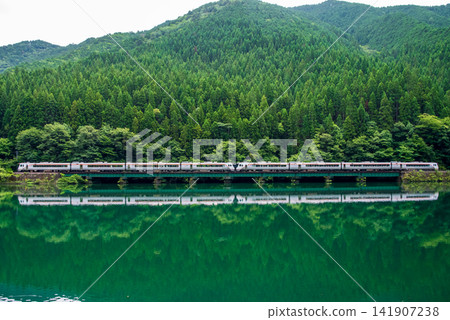 The JR Takayama Line's "Wide View Hida" limited express train travels across Shimohara Dam Lake. The JR Takayama Line's "Wide View Hida" limited express train travels across Shimohara Dam Lake. 141907238