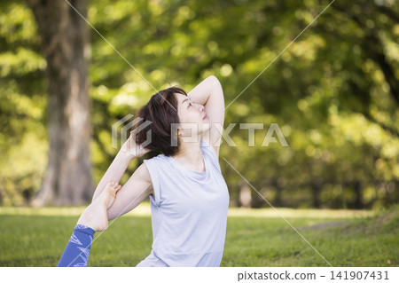 Women doing yoga outdoors Women doing yoga outdoors 141907431