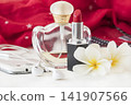 lipsticks, perfume, red scarf and mobile phone accessories of lifestyle woman  141907566