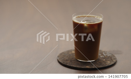pour espresso in glass with orange juice to make Bumble coffee 141907705