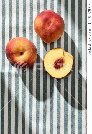 fresh ripe peaches on striped tablecloth background fresh ripe peaches on striped tablecloth background 141907979