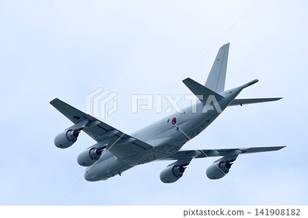 A large jet plane flies overhead, circling in the blue sky. A large jet plane flies overhead, circling in the blue sky. 141908182