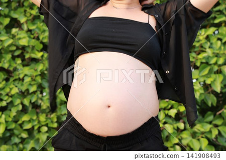 Pregnant Woman Enjoying a Peaceful Outdoor Moment Pregnant Woman Enjoying a Peaceful Outdoor Moment 141908493