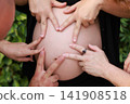 Pregnant Woman Enjoying a Peaceful Outdoor Moment 141908518