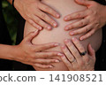 Pregnant Woman Enjoying a Peaceful Outdoor Moment 141908521