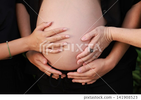 Pregnant Woman Enjoying a Peaceful Outdoor Moment Pregnant Woman Enjoying a Peaceful Outdoor Moment 141908523