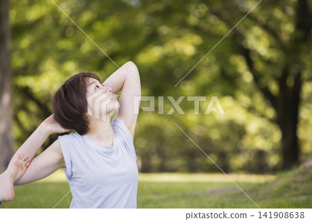 Women doing yoga outdoors Women doing yoga outdoors 141908638