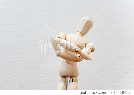 A drawing mannequin with its arms crossed, deep in thought. A drawing mannequin with its arms crossed, deep in thought. 141908702