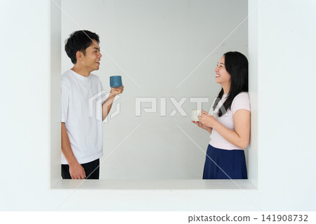 A young man and woman talking in a relaxed room A young man and woman talking in a relaxed room 141908732