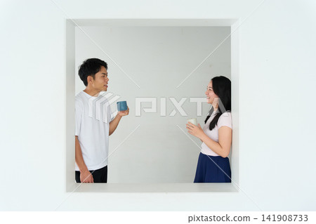 A young man and woman talking in a relaxed room A young man and woman talking in a relaxed room 141908733
