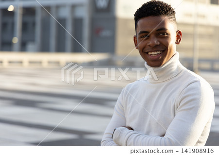 African American teen standing on plaza in white turtleneck, paving or railing or building, copy spa African American teen standing on plaza in white turtleneck, paving or railing or building, copy spa 141908916