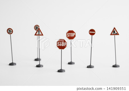 Miniature road traffic signs isolated on white background 141909351