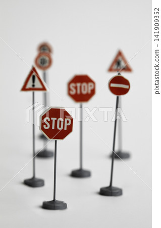 Miniature road traffic signs isolated on white background Miniature road traffic signs isolated on white background 141909352