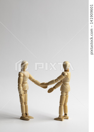 Two wooden figures shaking hands Two wooden figures shaking hands 141909601