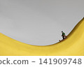Miniature man skiing on a yellow ripe banana 141909748