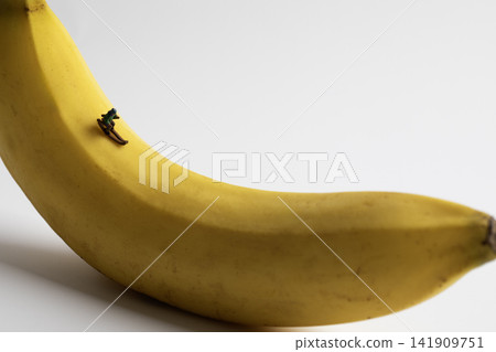 Miniature man skiing on a yellow ripe banana Miniature man skiing on a yellow ripe banana 141909751