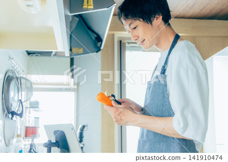 A young man cooking A young man cooking 141910474