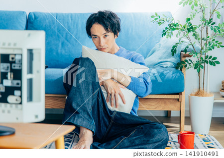 young man watching tv young man watching tv 141910491
