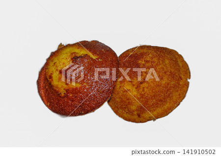 Two freshly baked golden brown ada cakes isolated on a plain white background. Two freshly baked golden brown ada cakes isolated on a plain white background. 141910502