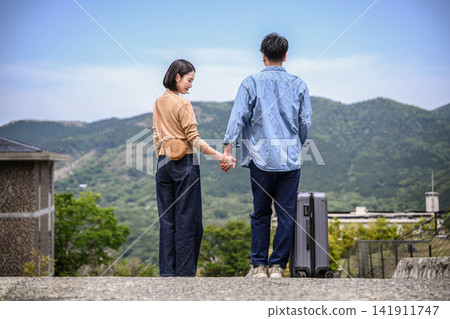 The two hold hands, anticipating the start of their journey. The two hold hands, anticipating the start of their journey. 141911747