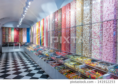 showcase of candy shop, transparent container with various sweets, marshmallow, jelly, chewy gums, rich sugar assortment showcase of candy shop, transparent container with various sweets, marshmallow, jelly, chewy gums, rich sugar assortment 141912253