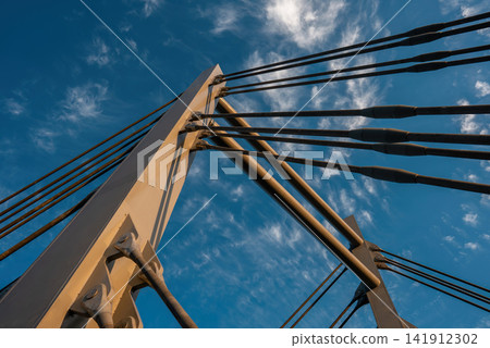 modern metal cable bridge imeni Kaczorowskiego on blue sky background, Lublin modern metal cable bridge imeni Kaczorowskiego on blue sky background, Lublin 141912302