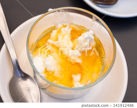 Mato with honey served with teaspoon Mato with honey served with teaspoon 141912486