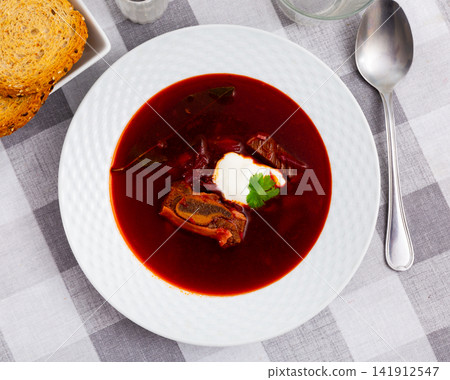 Just prepared portion of svekolnik served with parsley and smetana Just prepared portion of svekolnik served with parsley and smetana 141912547