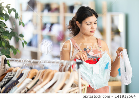 Latina chooses panties in a clothing store Latina chooses panties in a clothing store 141912564