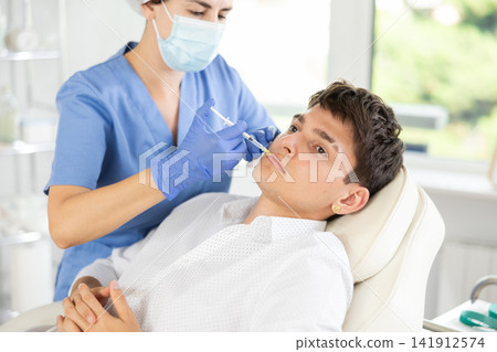Facial injection male patient 141912574