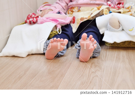 幼兒的腳踩在木地板上;赤腳的孩子在木地板上;兒童房;赤腳的孩子;圖片素材。 幼兒的腳踩在木地板上;赤腳的孩子在木地板上;兒童房;赤腳的孩子;圖片素材。 141912716