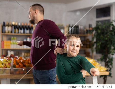 Emotional child in a supermarket 141912751