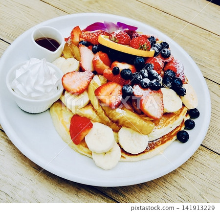 A café time with pancakes overflowing with fruit and lemonade. A café time with pancakes overflowing with fruit and lemonade. 141913229