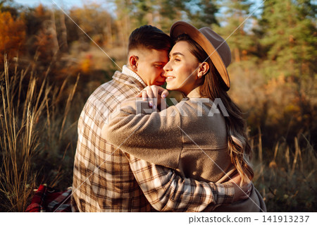 Stylish couple walking and enjoying autumn weather. People, lifestyle, vacations concept. Autumn. Stylish couple walking and enjoying autumn weather. People, lifestyle, vacations concept. Autumn. 141913237