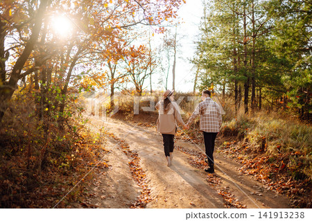 Stylish couple walking and enjoying autumn weather. People, lifestyle, vacations concept. Autumn. Stylish couple walking and enjoying autumn weather. People, lifestyle, vacations concept. Autumn. 141913238