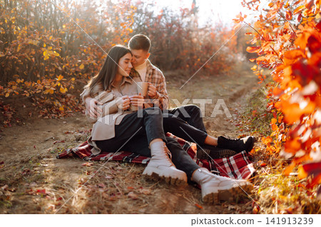Stylish couple walking and enjoying autumn weather. People, lifestyle, vacations concept. Autumn. Stylish couple walking and enjoying autumn weather. People, lifestyle, vacations concept. Autumn. 141913239
