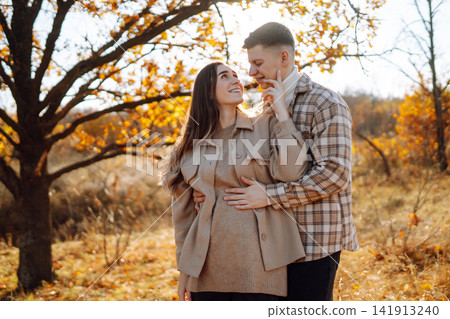 Stylish couple walking and enjoying autumn weather. People, lifestyle, vacations concept. Autumn. 141913240