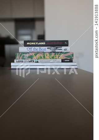 Stack of Books and Magazines on Wooden Table with Copy Space Stack of Books and Magazines on Wooden Table with Copy Space 141913888