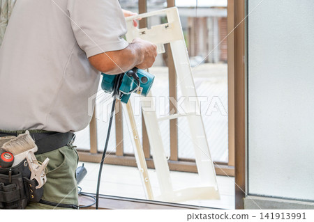 Air conditioner cleaning; a man from the air conditioner maintenance company. Air conditioner cleaning; a man from the air conditioner maintenance company. 141913991