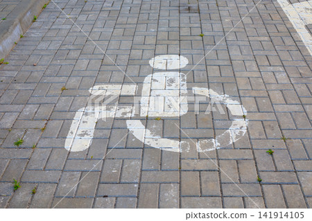 Disabled Parking Sign Painted White on Paving Slabs Ground Surface Disabled Parking Sign Painted White on Paving Slabs Ground Surface 141914105