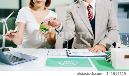 business team people planning and discussing on recycle reduce reuse policy symbol in office meeting room. Green business company and Solar Energy Environment city Concept. business team people planning and discussing on recycle reduce reuse policy symbol in office meeting room. Green business company and Solar Energy Environment city Concept. 141914819