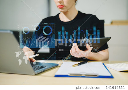 Close up Businesswoman hand Project manager working and update tasks and Gantt chart scheduling virtual diagram.with smart phone, tablet and laptop in office. 141914831