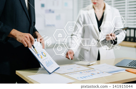 Working team meeting concept,businessman using smart phone and laptop and digital tablet computer in modern office with virtual interface icons network diagram at modern office i Working team meeting concept,businessman using smart phone and laptop and digital tablet computer in modern office with virtual interface icons network diagram at modern office i 141915044